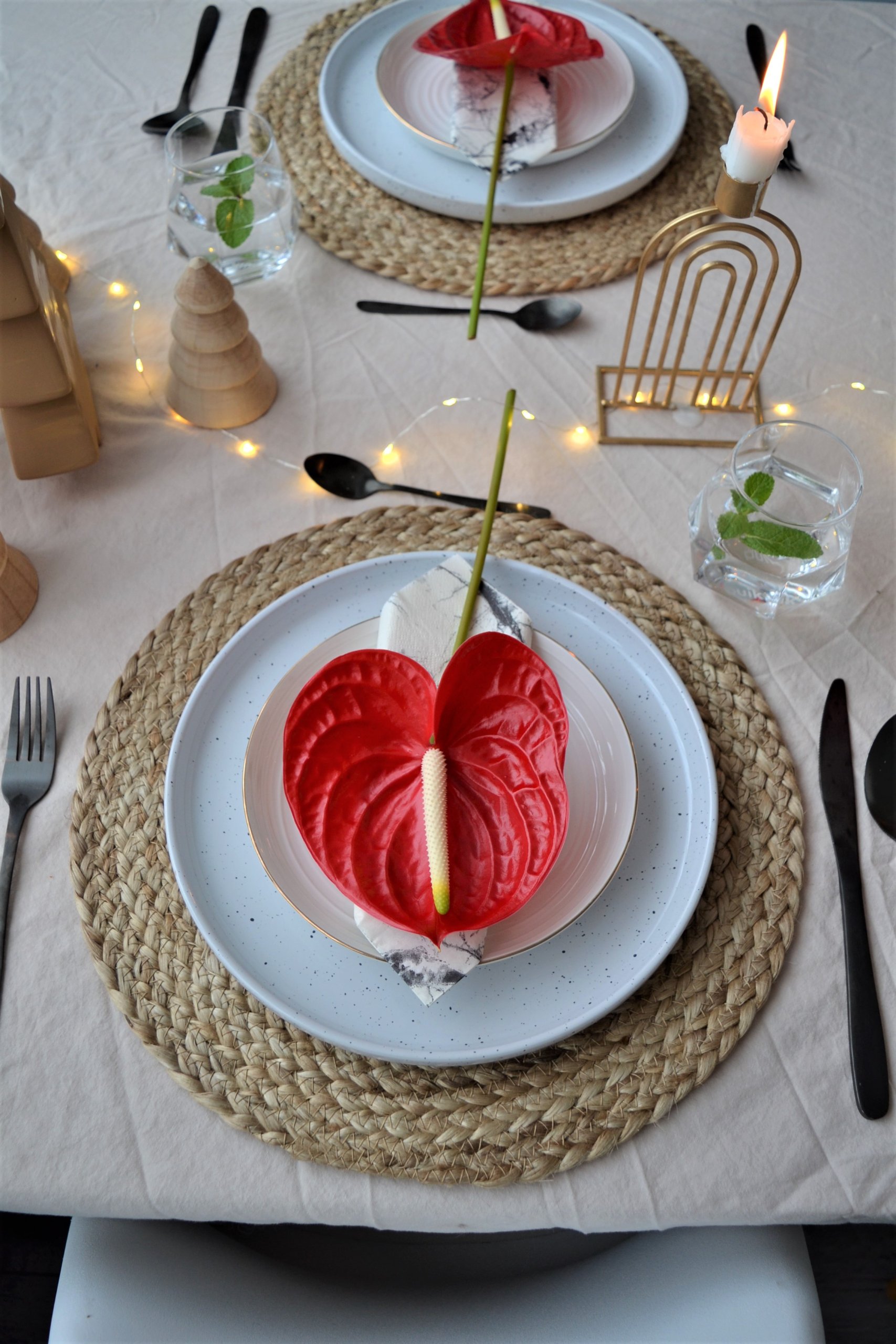 Christmas table setting with red Anthurium flowers