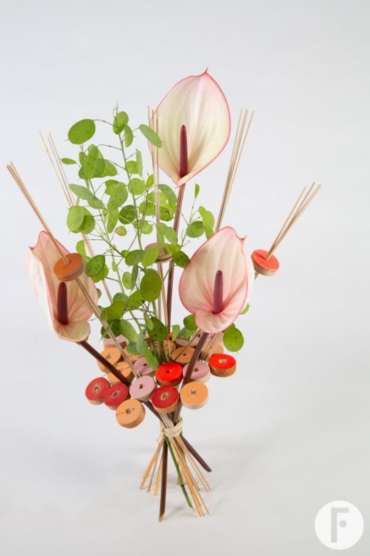 Anthurium bouquet in frame of wooden discs